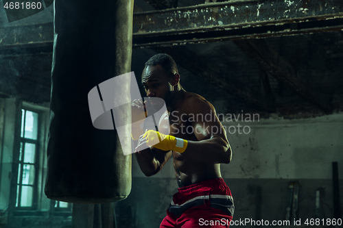 Image of Hand of boxer over black background. Strength, attack and motion concept