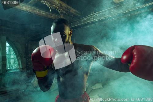 Image of Hand of boxer over black background. Strength, attack and motion concept