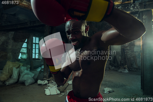 Image of Hand of boxer over black background. Strength, attack and motion concept