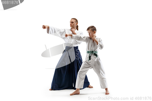 Image of Man and teen boy fighting at aikido training in martial arts school