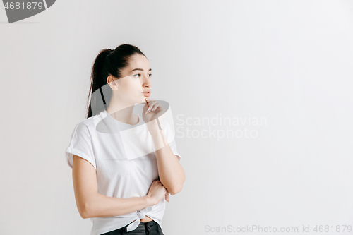 Image of Young serious thoughtful business woman. Doubt concept.