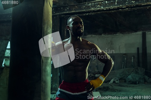 Image of Hand of boxer over black background. Strength, attack and motion concept