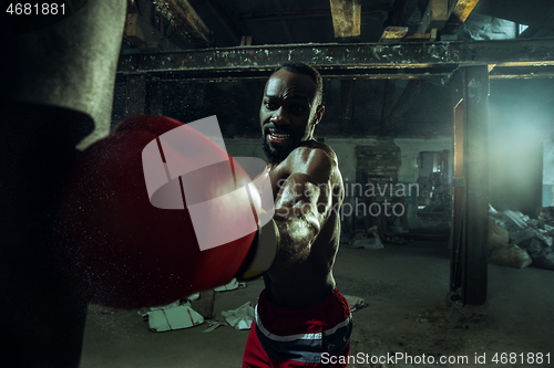 Image of Hand of boxer over black background. Strength, attack and motion concept