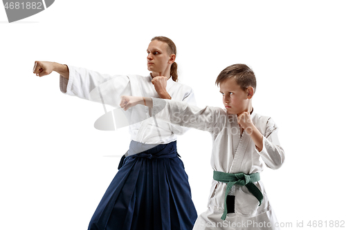 Image of Man and teen boy fighting at aikido training in martial arts school