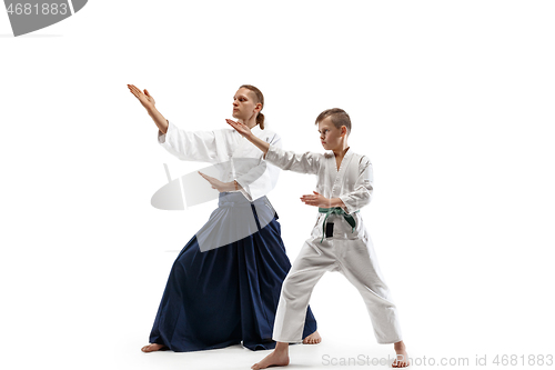 Image of Man and teen boy fighting at aikido training in martial arts school