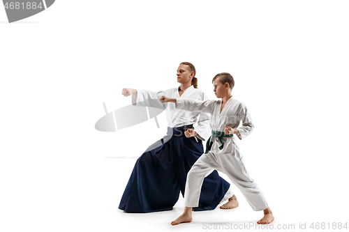 Image of Man and teen boy fighting at aikido training in martial arts school