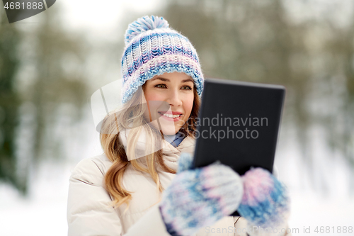 Image of woman with tablet computer outdoors in winter