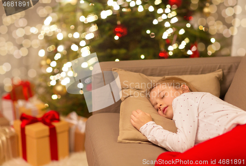 Image of girl sleeping on sofa at christmas