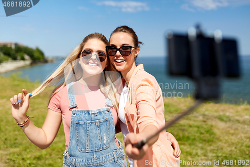 Image of teenage girls or friends taking selfie in summer