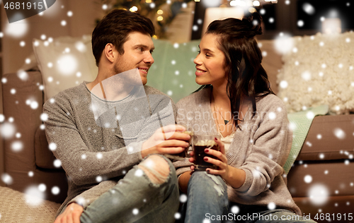 Image of happy couple drinking coffee and eating at home