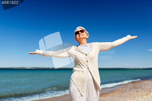 Image of portrait of senior woman in sunglasses on beach