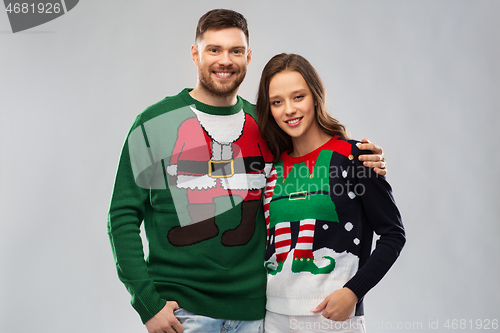 Image of happy couple at christmas ugly sweater party