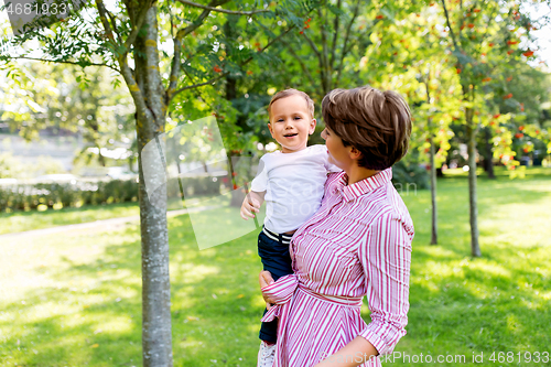 Image of happy mother with little son in summer park