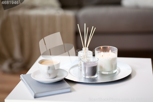 Image of coffee, candles and aroma reed diffuser on table