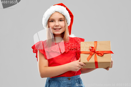 Image of smiling girl in snata hat with christmas gift