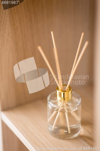 Image of aroma reed diffuser on wooden shelf