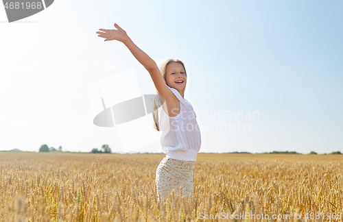 Image of happy smiling young girl on cereal field in summer