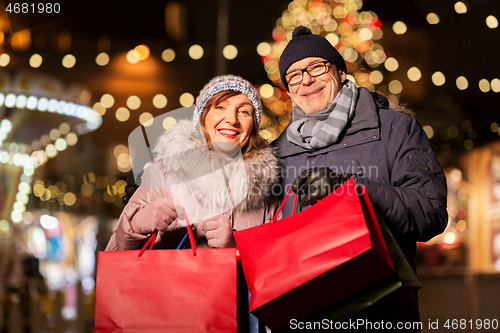 Image of old couple at christmas market with shopping bags