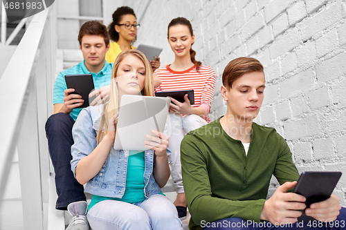 Image of high school students with tablet computers