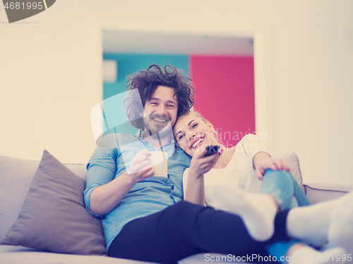 Image of Young couple on the sofa watching television