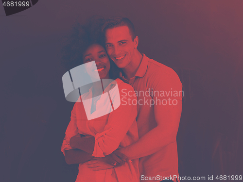 Image of multiethnic couple in front of gray chalkboard