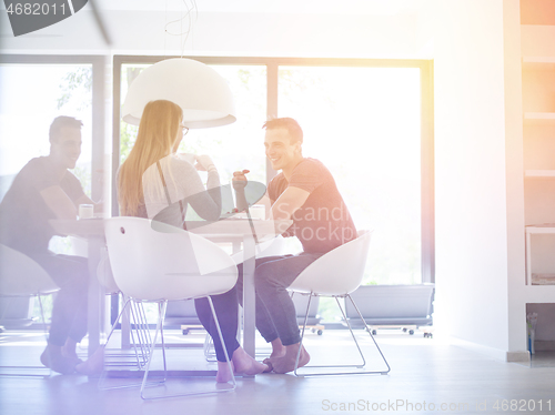 Image of couple enjoying morning coffee and strawberries