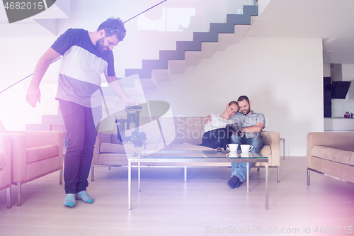 Image of romantic couple relaxing at  home with tablet computers