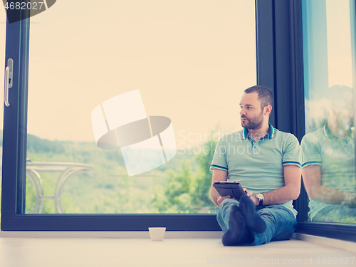 Image of man on the floor enjoying relaxing lifestyle