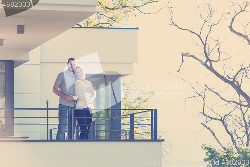 Image of couple enjoying morning coffee on balcony