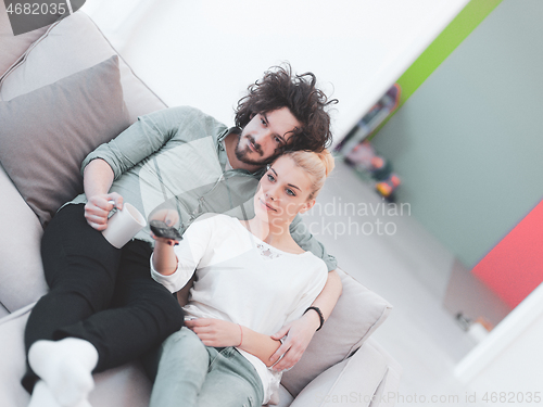 Image of Young couple on the sofa watching television