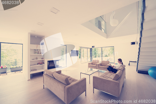 Image of handsome woman using tablet computer on sofa