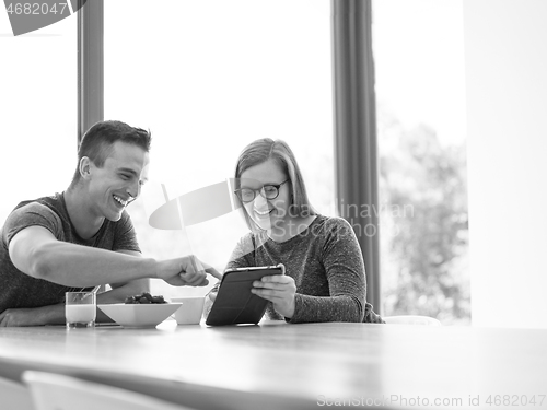 Image of couple enjoying morning coffee and strawberries