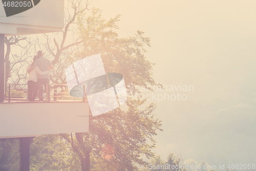 Image of couple enjoying morning coffee on balcony