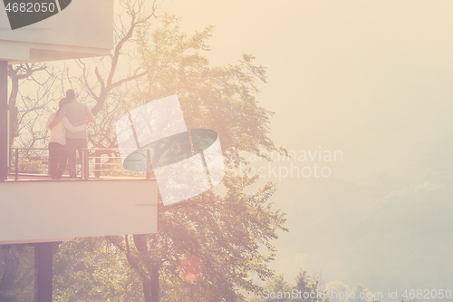 Image of couple enjoying morning coffee on balcony