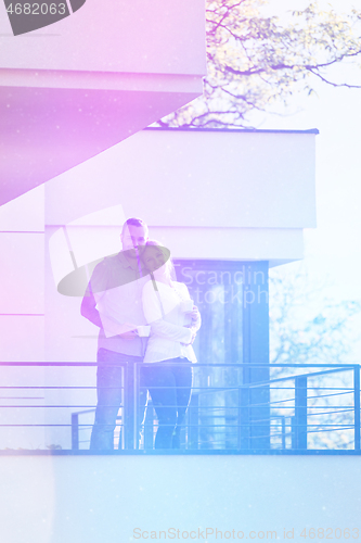 Image of couple enjoying morning coffee on balcony