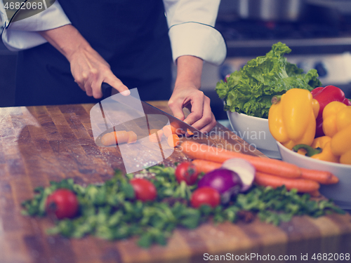 Image of chef hands cutting carrots