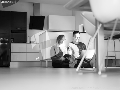 Image of couple using tablet and laptop computers