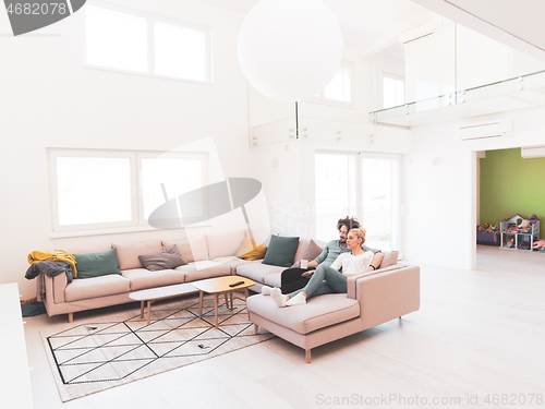 Image of Young couple on the sofa watching television