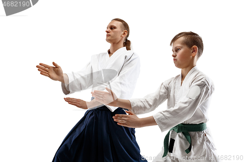 Image of Man and teen boy fighting at aikido training in martial arts school