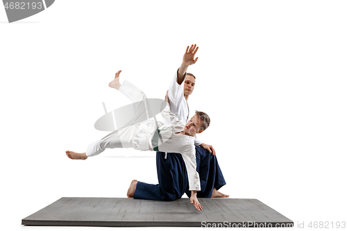 Image of Man and teen boy fighting at aikido training in martial arts school