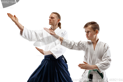 Image of Man and teen boy fighting at aikido training in martial arts school