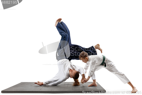 Image of Man and teen boy fighting at aikido training in martial arts school