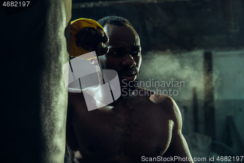 Image of Hand of boxer over black background. Strength, attack and motion concept