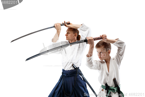 Image of Man and teen boy fighting at aikido training in martial arts school