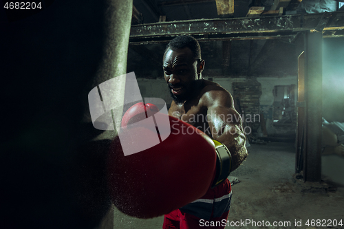 Image of Hand of boxer over black background. Strength, attack and motion concept