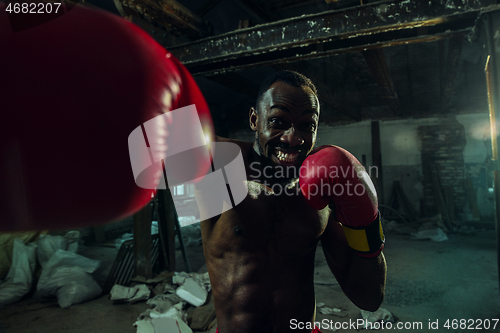 Image of Hand of boxer over black background. Strength, attack and motion concept