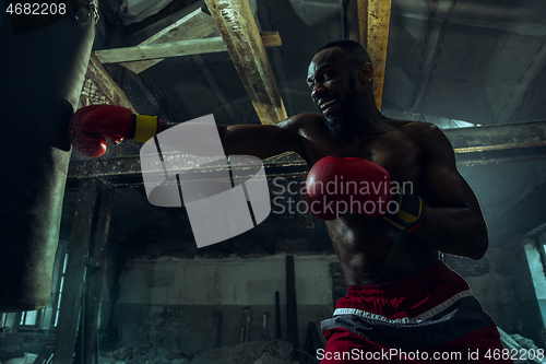 Image of Hand of boxer over black background. Strength, attack and motion concept