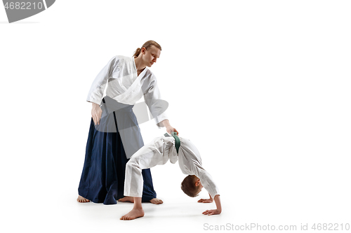 Image of Man and teen boy fighting at aikido training in martial arts school