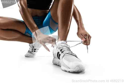 Image of Young african woman running or jogging isolated on white studio background.