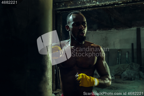 Image of Hand of boxer over black background. Strength, attack and motion concept